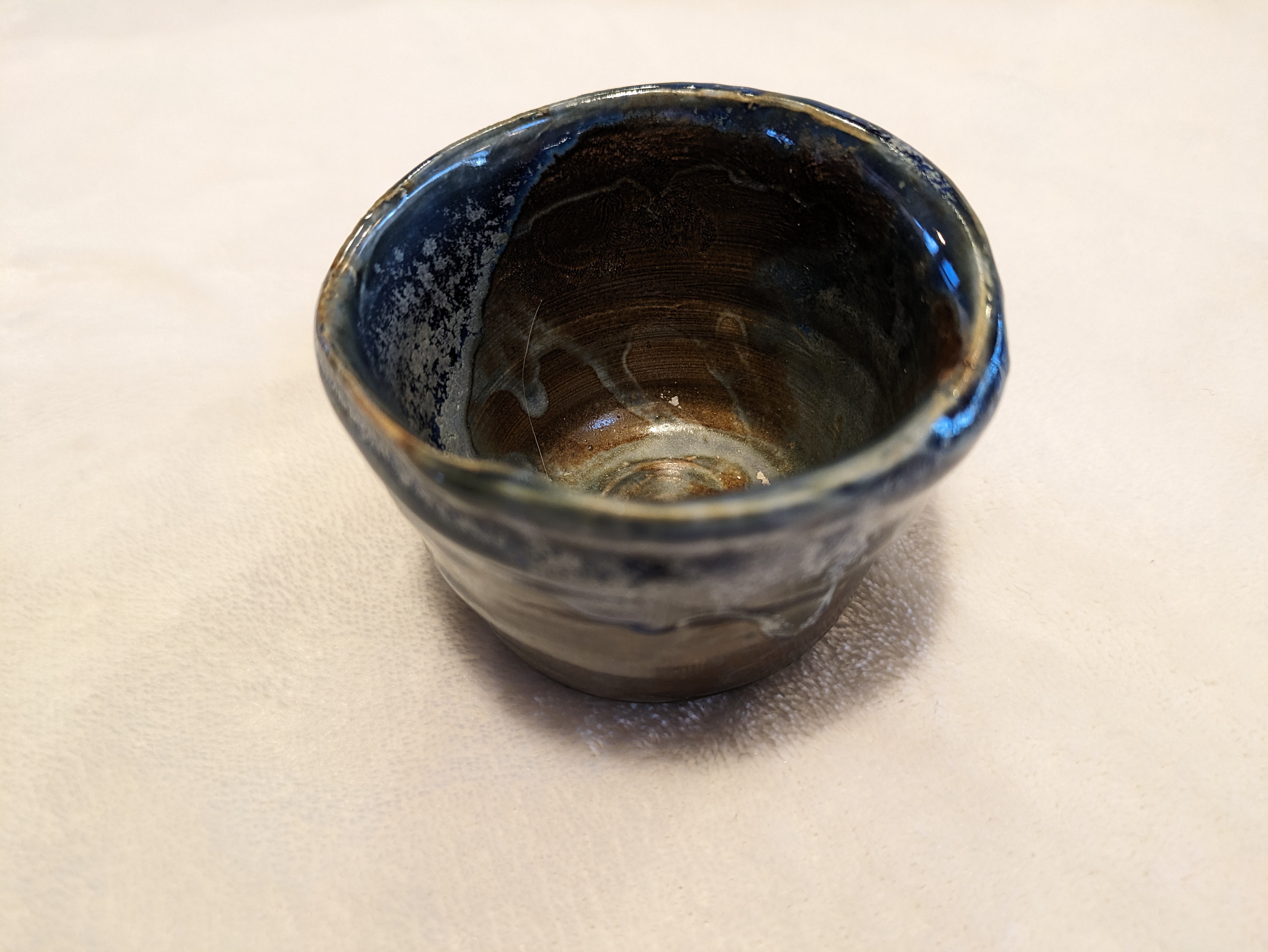 Blue and bronze teacup - top view